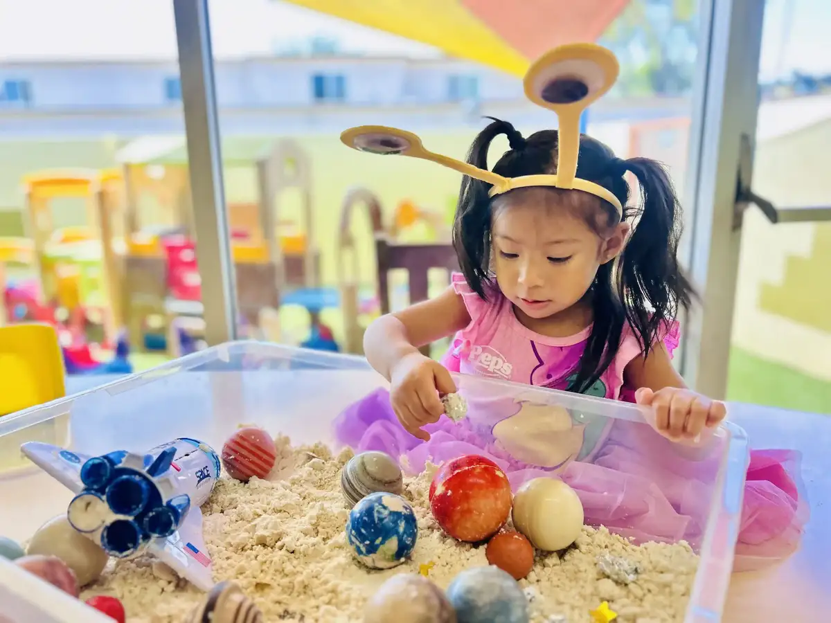 Infants exploring a sensory activity that supports early motor and cognitive development at O.C. Kids Preschool