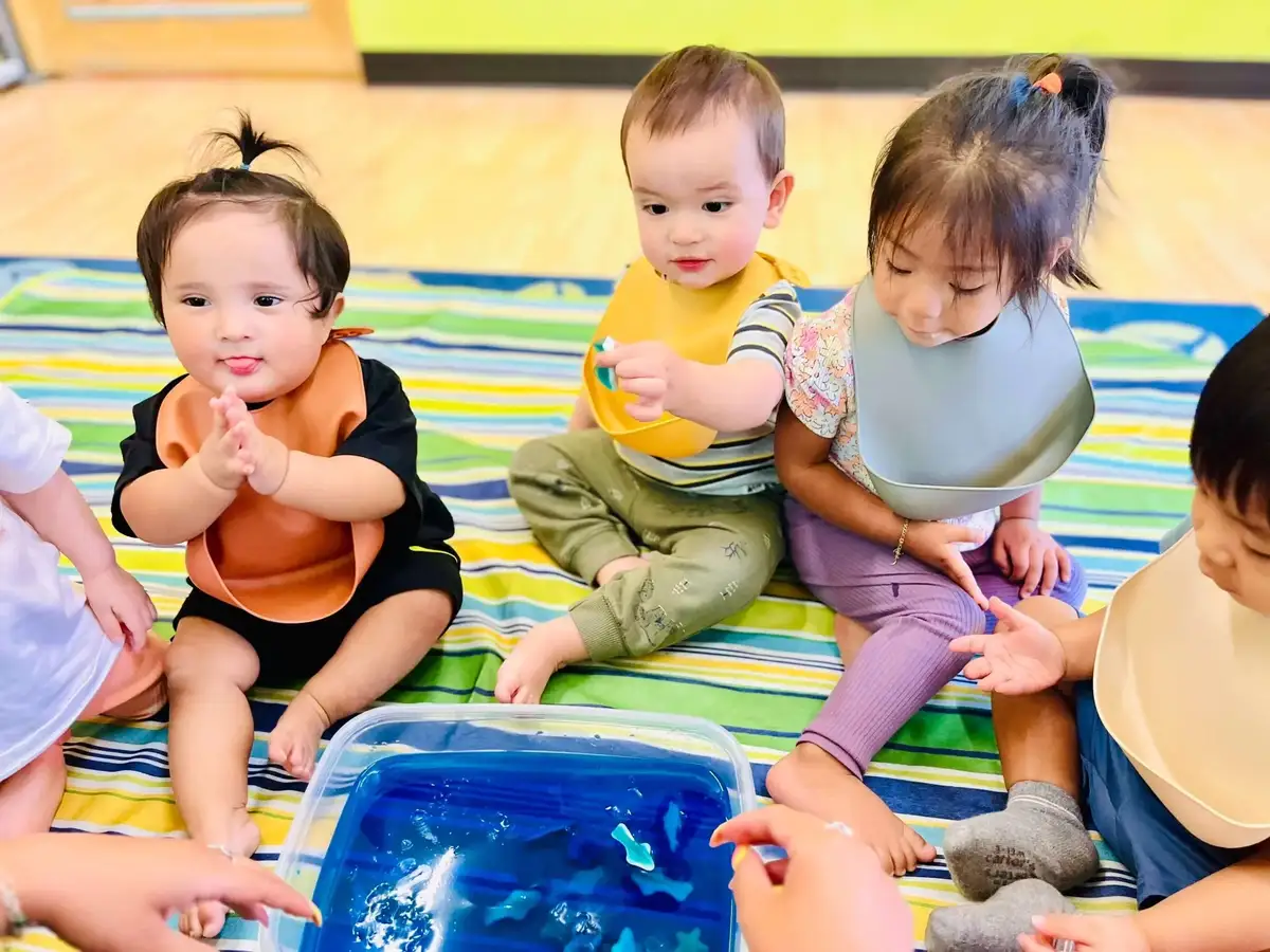 Experienced and caring teachers nurturing toddlers in a safe, secure classroom environment at O.C. Kids Preschool