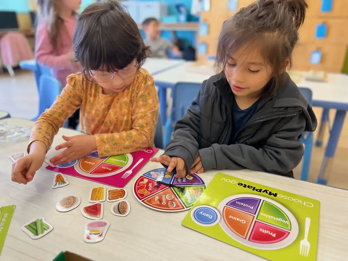 Children engaged in hands-on themed learning activities centered on discovery, science, and exploration at O.C. Kids…