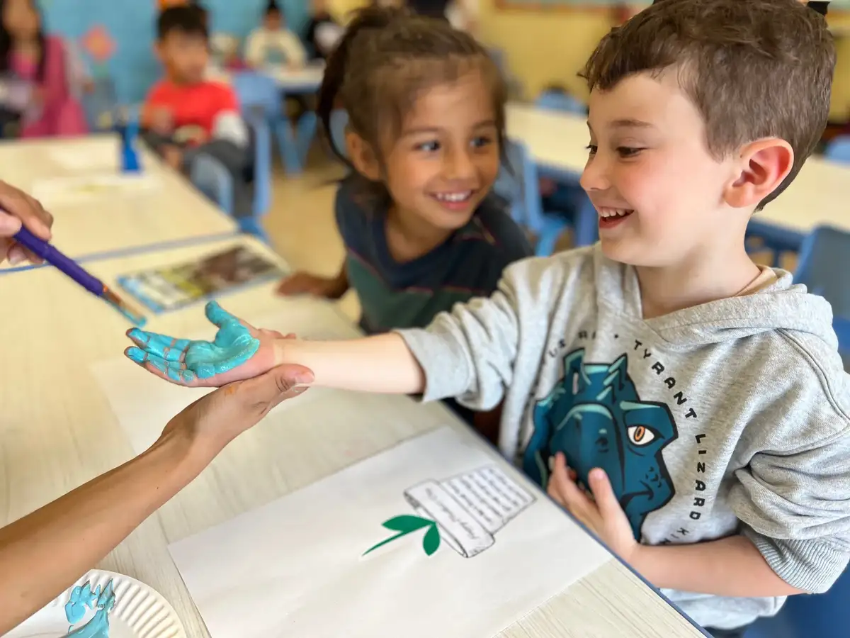 Four to five year old children engaging in theme-based learning with Montessori materials, science experiments, and…