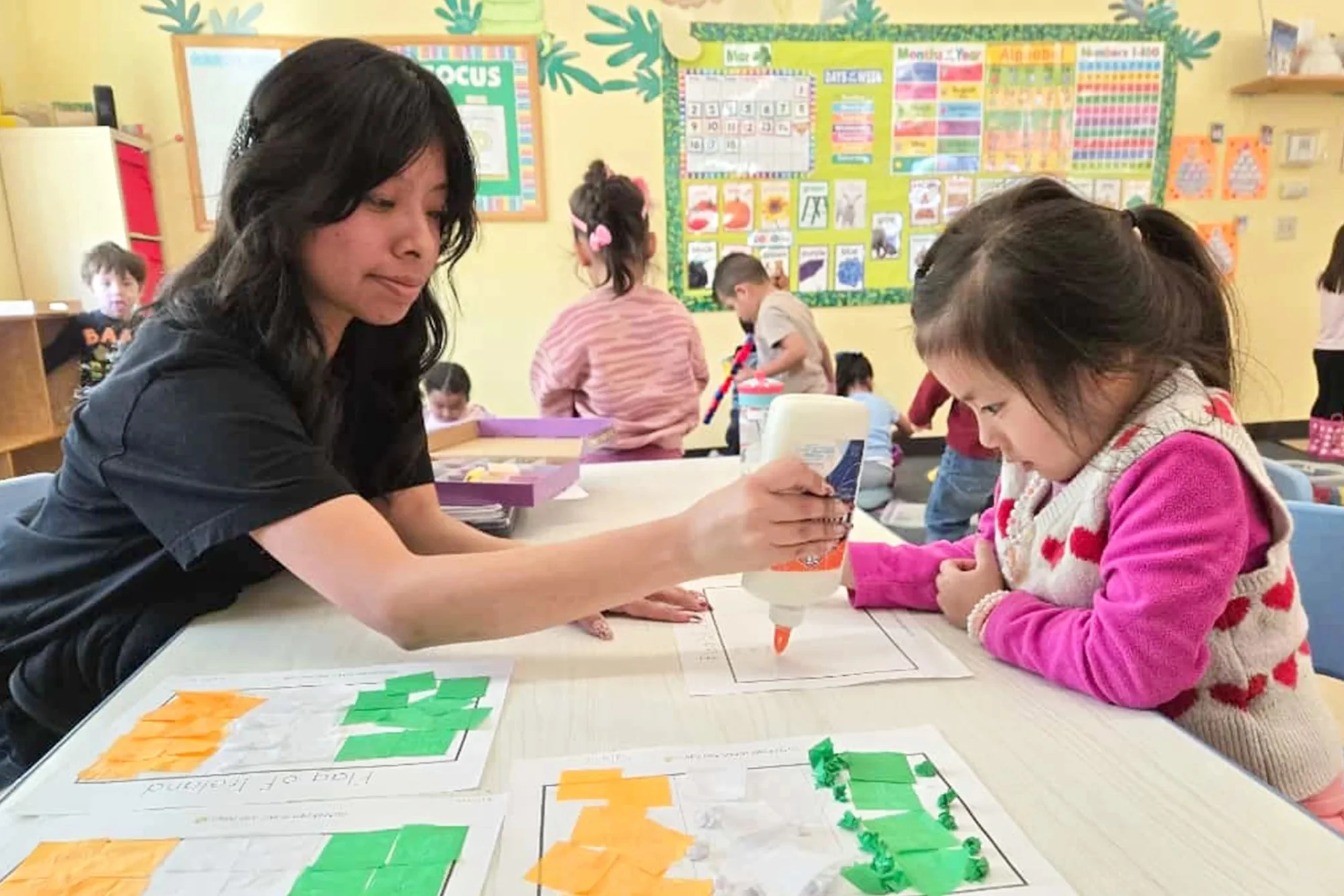 OC Kids Preschool teacher working one-on-one with a child in Garden Grove