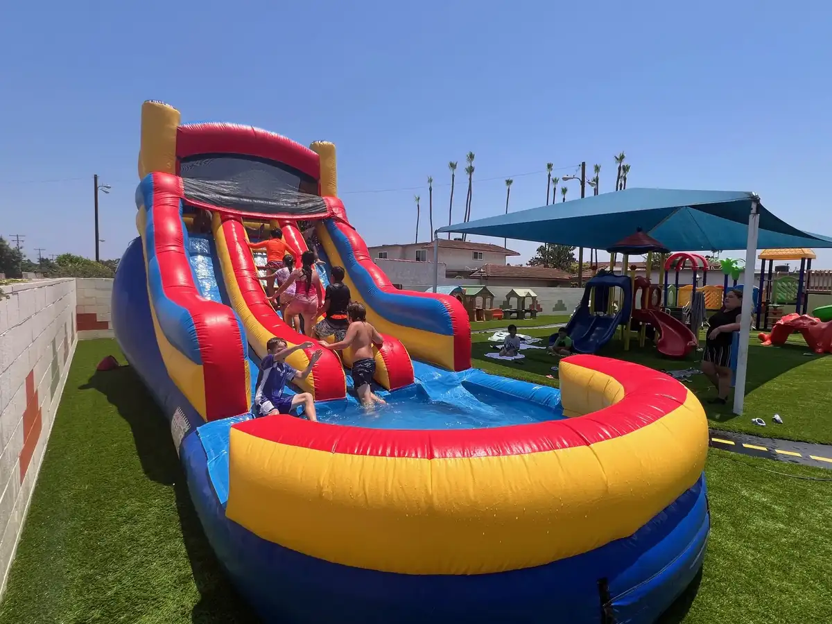 Preschool children enjoying outdoor water play at O.C. Kids Preschool