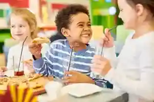 Children enjoying hot lunch meals at OC Kids Preschool Garden Grove